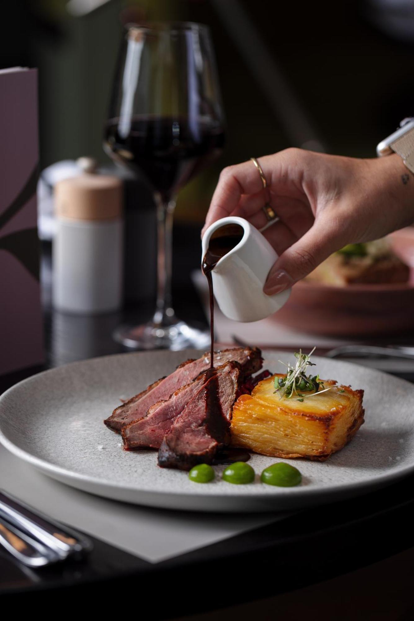 Отель The Morrison Dublin, Curio Collection By Hilton Экстерьер фото A steak being drizzled with a sauce